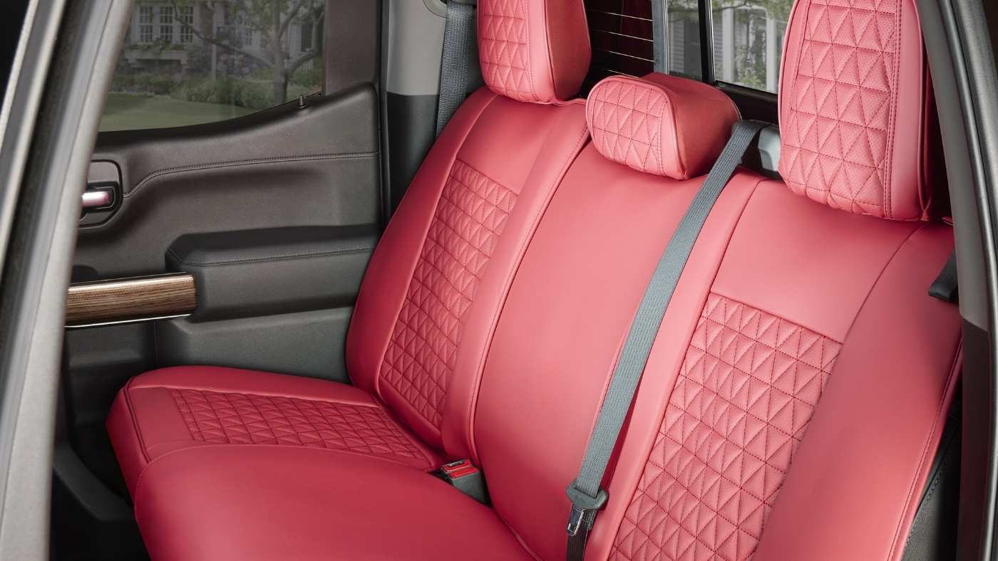Custom-fit red leather car seat covers installed on rear seats, featured in best dog seat covers for 2026 guide.