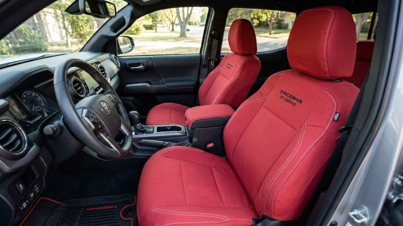 Red canvas seat covers installed in a truck; show durable fabric design suited for work trucks and rugged daily use builds.