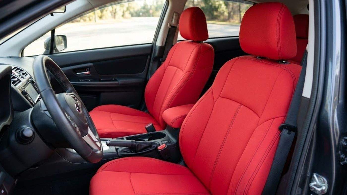 Bright red neoprene seat covers installed in a car; show waterproof sport design for drivers upgrading seats with bold color.