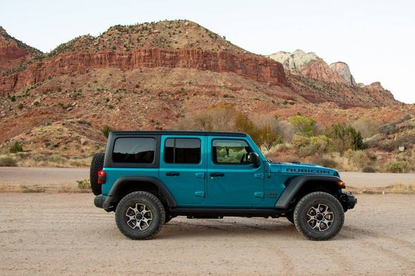 2020 Jeep Wrangler Unlimited in blue, side profile view against mountain backdrop