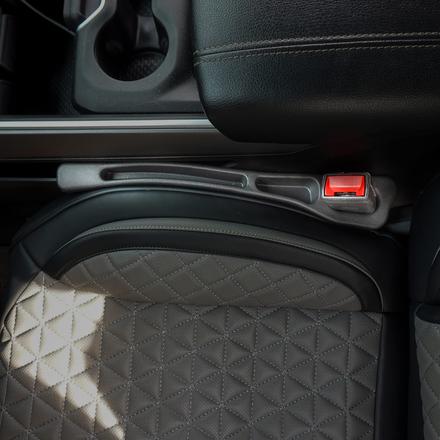 Phone gap filler accessory with mobile cable next to seat cover