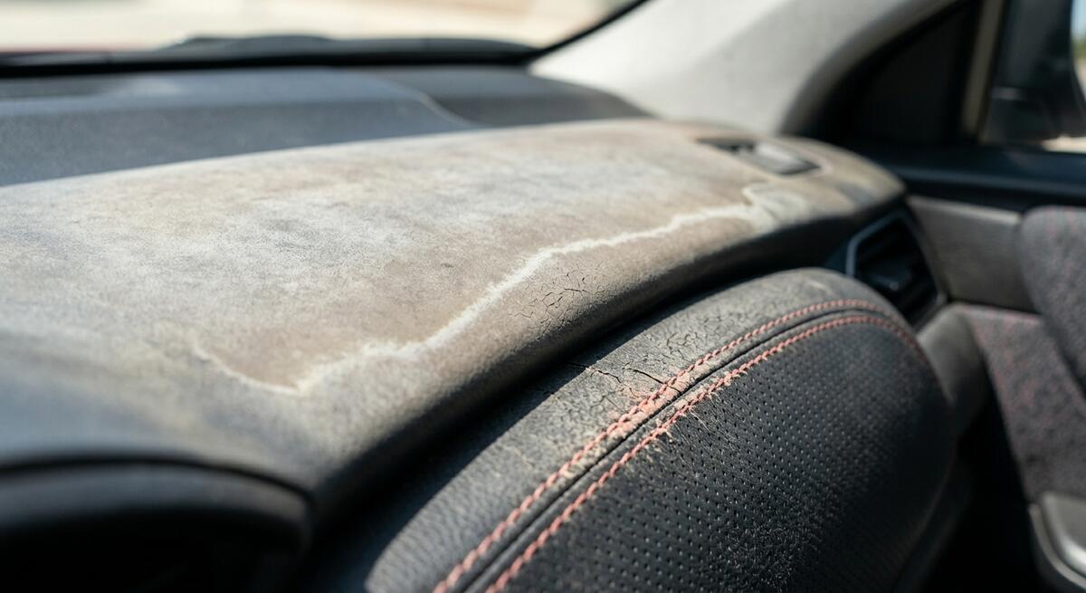 Worn Ford F-150 Raptor SuperCrew dashboard and seat edge after 50,000 miles of dusty off-road driving daily wear.