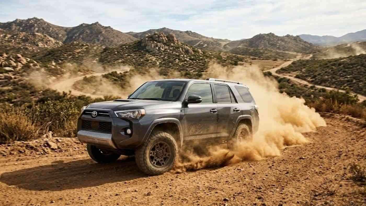 Dust-covered off-road SUV kicking up dirt trails, reflecting how grime and dust quickly age rugged interiors fast.