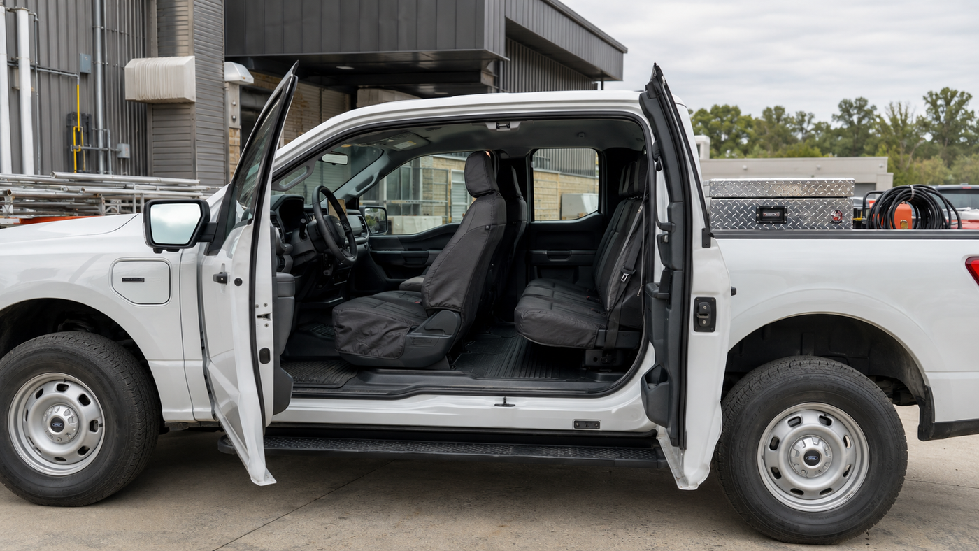 Ford F-150 Lightning Pro interior with commercial-grade seat covers installed for fleet durability & daily work-truck safety.