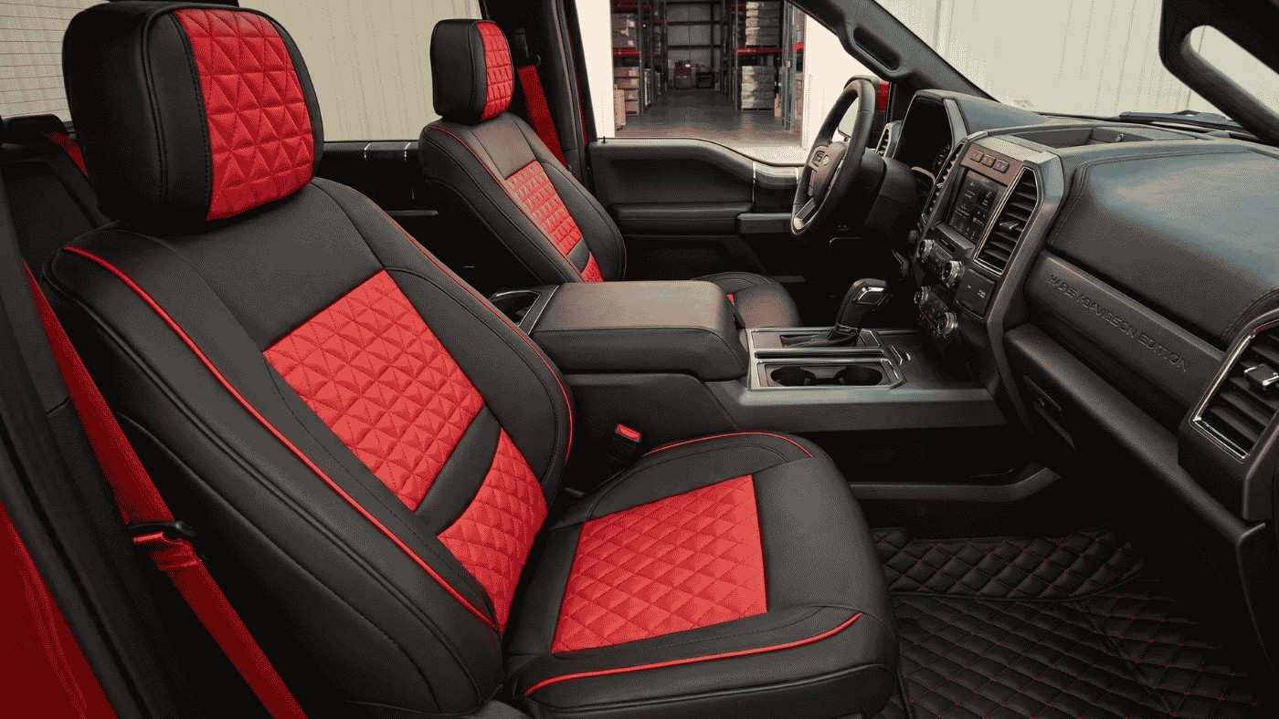 Custom red and black seat covers inside a Ford F-150, showing reversible protection for collector-grade interiors.