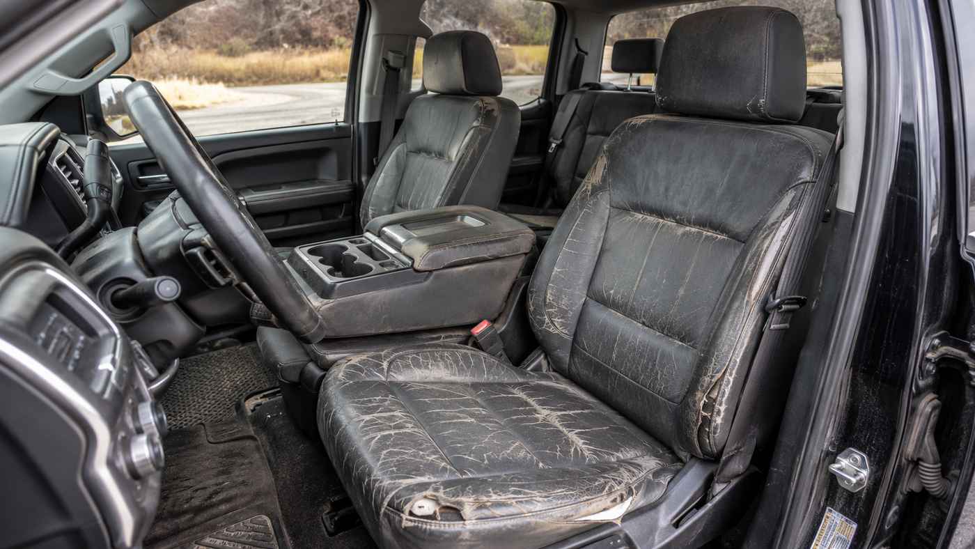 Worn Chevrolet Silverado 1500 Crew Cab front seats highlighting Silverado 1500 Crew Cab Seat Covers for daily family use.