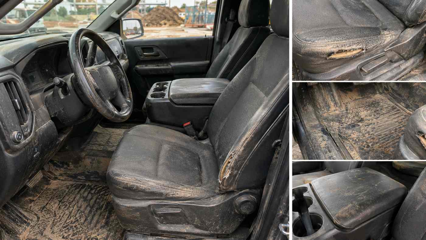 Worn Silverado 1500 Work Truck interior showing stained cloth seats after three years of contractor job-site use.