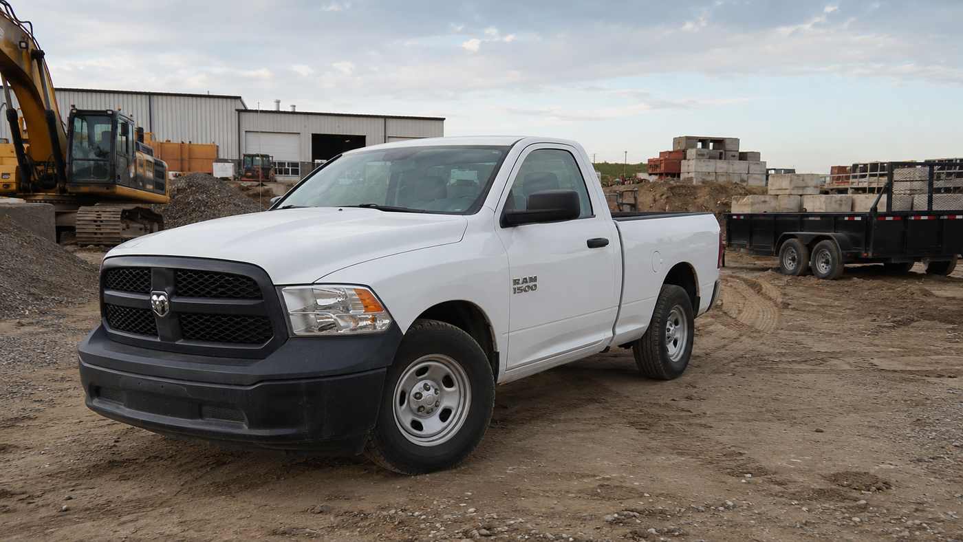 White Ram 1500 Tradesman parked on a job site reflecting the Ram 1500 Tradesman Interior made for tough daily work.