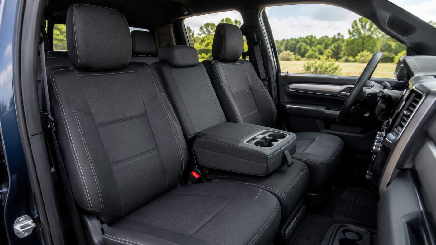 Custom seat covers fitted on a Ram 1500 40/20/40 bench seat with fold-down center console preserving fit and function.