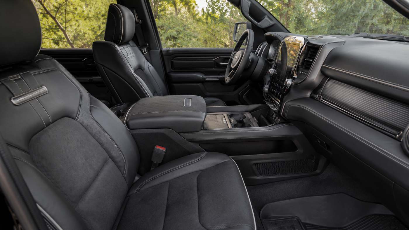 Ram 1500 Limited interior with clean suede and Natura Plus leather front seats, highlighting the premium cabin before wear.