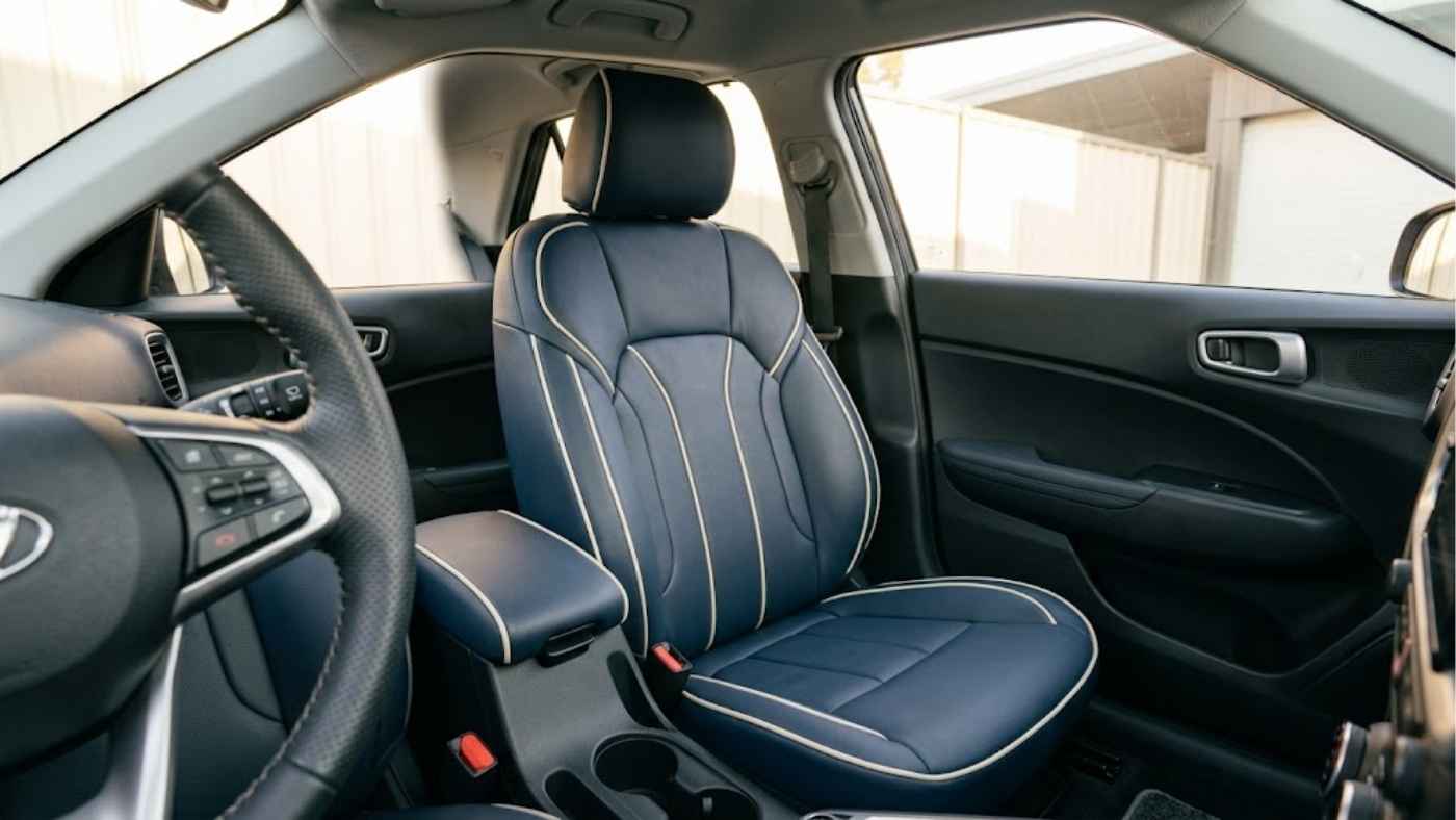 Navy eco-leather seat covers with cream contrast piping adding a premium, factory-inspired finish to the vehicle interior.