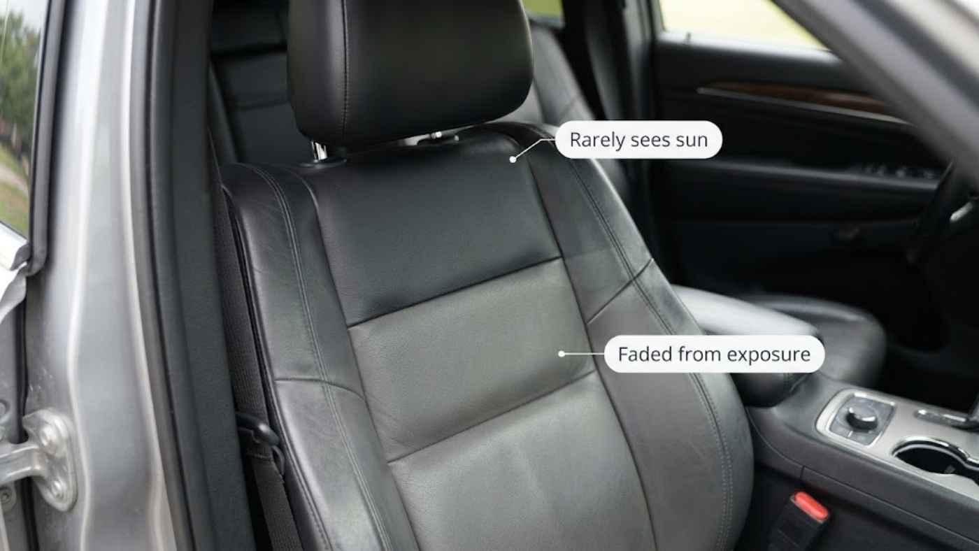 Grand Cherokee Overland seat showing unfaded leather under the headrest next to a sun faded cushion